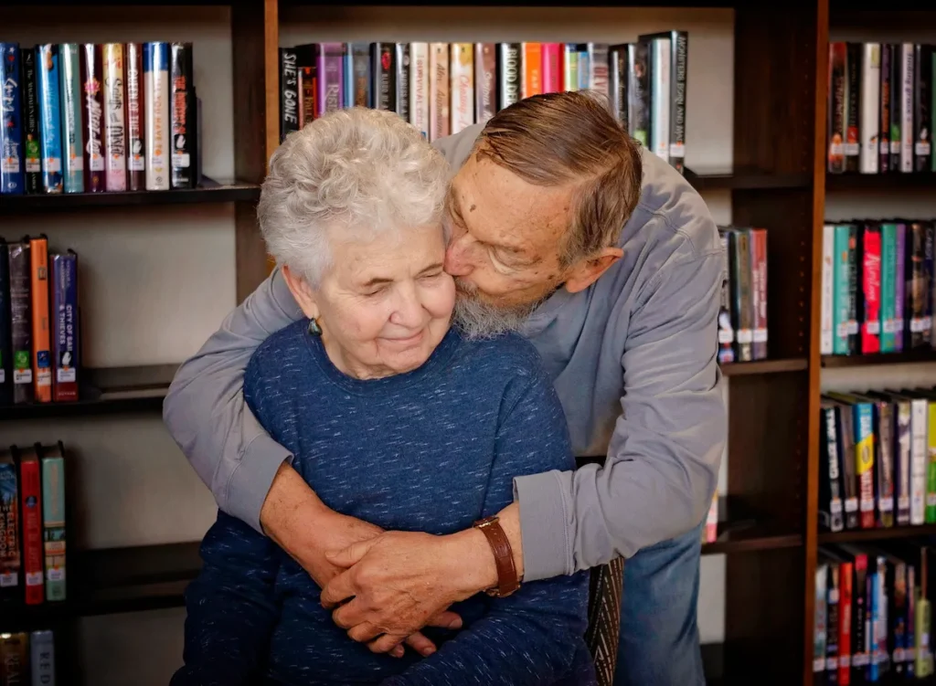 Older man kissing his wife on the cheek