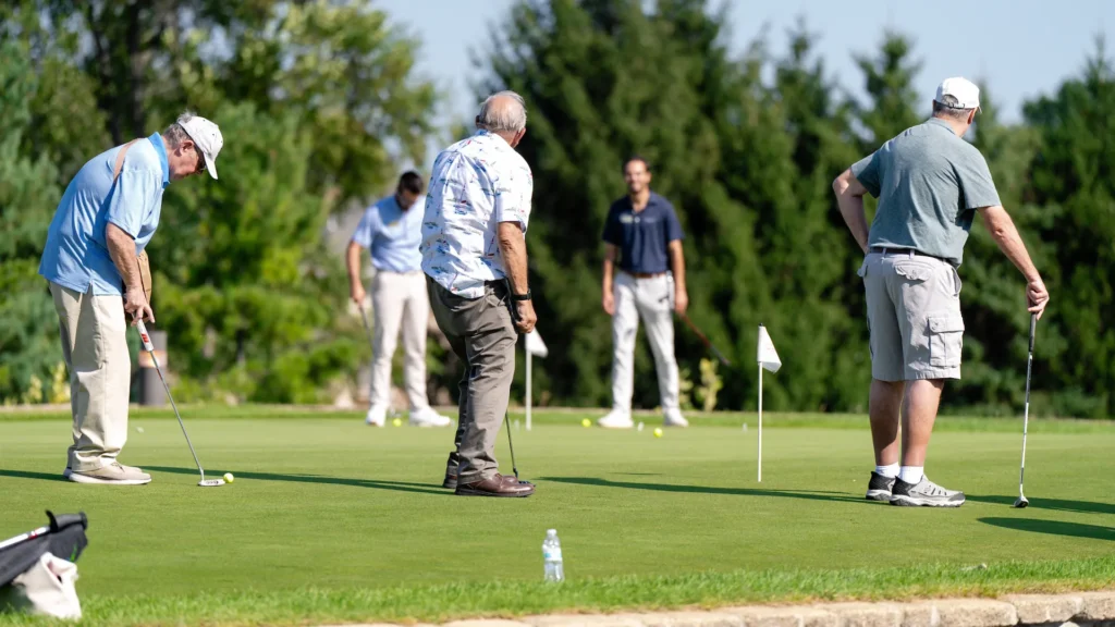 Group of older men playing golf together