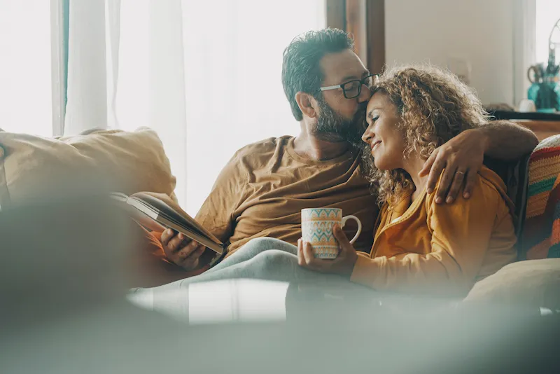 Happy couple reading on the couch