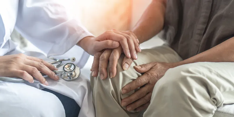 Doctor holding a patient's hand