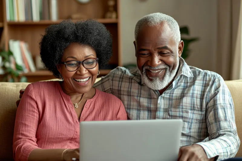 Smiling couple looking at their computer
