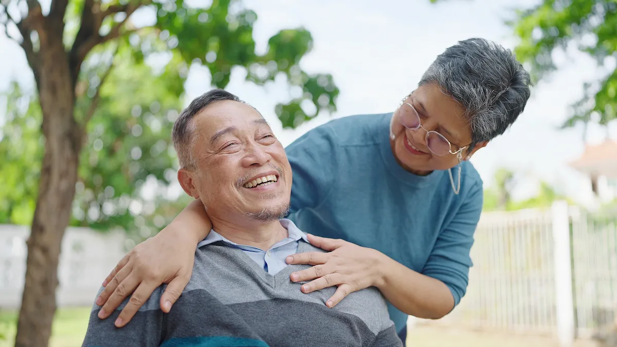 Elderly man sharing a smile with his caretaker