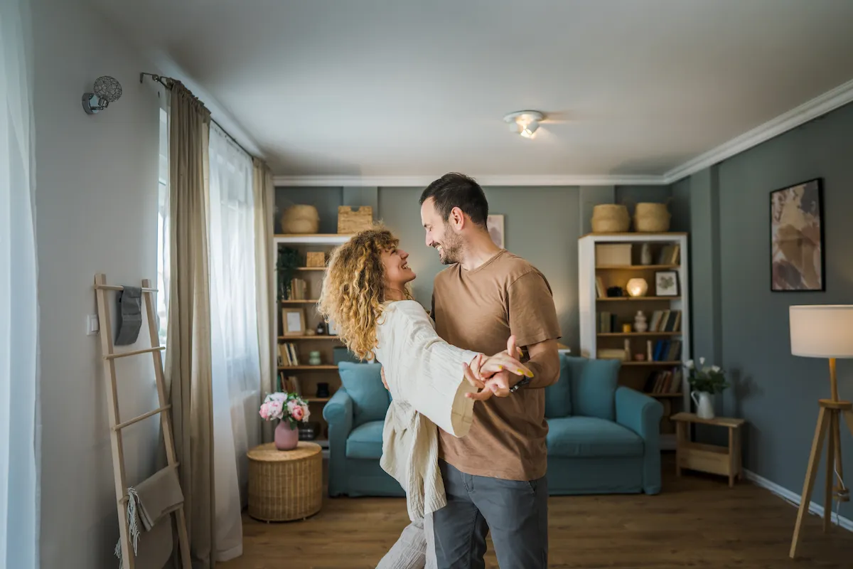 Man and woman dancing in their living room