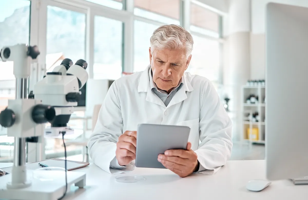 Doctor studying on electric tablet